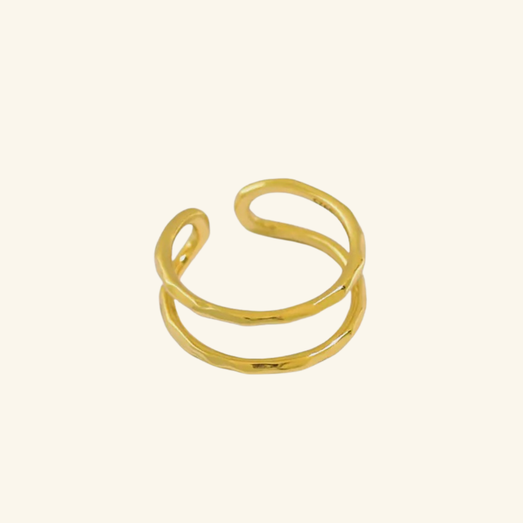 Gold ring on a beige background