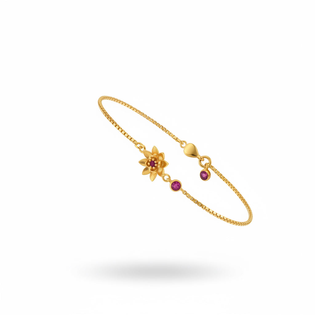Gold bracelet with a floral design on a wrist