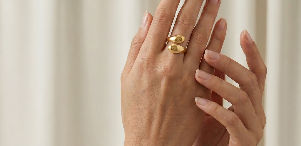 Silver bracelet and gold ring on a neutral background